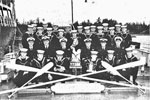 The crew of HMCS Jonquiere with their Pacific Fleet Cock of the Fleet trophy in 1961.