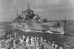 HMS Devonshire coming alongside HMS Mauritius in he Indian Ocean to pass the mail. October 1942. Photo: Lt. H. A. Mason. Imperial War Museums A 13456