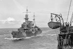 HMS Frobisher escorting a convoy, shown closing up on a troop ship to give orders verbally. June 16, 1942. Photo: Lt. F. G. Roper. Imperial War Museum A 10352