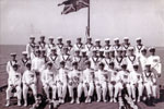 HMS Gambia Electrical Division, 1950 - 1952. Front Row L-R: EA3 Algy  Longworth, EA3 Alan Clements (Clem) CEA Pete Sawyer, Next Unknown, Lt  McGowan, Commander Lock, Mr Wannicot, C Elect??, PO Elect Conner?, PO Electr??? Acting PO elect. Second Row: 3rd right EA4 Barry Partridge, far right PO Elect. Bell, under flag EM Hartland?. Photo from Alan Clements