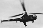 Dragonfly helicopter delivering mail, February 13, 1951. The helicopter is from USS Newport News (CA-148 Heavy Cruiser). Photo from my dad's albums.