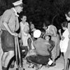 Naval ratings from HMS Daring administering first aid to sick refugees from Argostoli, August 1953. Image from Imperial War Museums, A32637