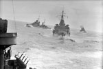 British naval escort and convoy in Mediterranean, September 1941, on board HMS Sheffield, escorting a Malta convoy in the Mediterranean (Operation Halberd). The convoy got through to Malta after being attacked by three groups of enemy torpedo carrying aircraft heavily escorted by fighters in the central Mediterranean. 14 enemy aircraft were destroyed and HMS Nelson was damaged by an aerial torpedo. Cruisers maneuvering at sea after they had escorted the convoy. Left to right: HMS Hermione, Edinburgh, Euralus. Photo: Lt. R. G. G. Coote. Imperial War Museum A 5746A