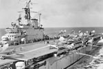 Sea Hawk aircraft of Nos 803 and 806 Squadron simultaneously firing their starting cartridges on the flight deck of the aircraft carrier HMS Centaur during flying operations in the Mediterranean near Malta. May 1955. Imperial War Museum A 33182