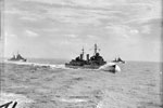 Escorting a convoy in the Mediterranean (Operation Halberd). The convoy got through to Malta after being attacked by three groups of enemy torpedo carrying aircraft heavily escorted by fighters in the central Mediterranean. 14 enemy aircraft were destroyed but HMS Nelson was damaged by an aerial torpedo. The escorting cruisers had a busy time, and are seen steaming fast to take up their positions. Left to right: HMS Hermione, HMS Edinburgh, HMS Euryalus. September 1941. Photo: Lt. R. G. G. Coote. Imperial War Museum A 5739