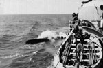 HMS Gambia firing a torpedo on exercise off of Lanarka, Cyprus in 1951. Dad's photo