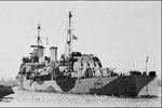 HMS Gambia. Being towed out in February 1942
