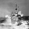 Units of the Mediterranean Fleet in line ahead firing a Royal Salute as they pass Her Majesty The Queen on board HMY Britannia. The cruiser HMS Gambia is in the foreground. May 1954. Imperial War Museum A 32924