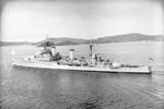 HMS Gambia, flying her Paying Off pennant leaving Trincomalee on the start of her journey back to the UK, with her ship's company manning and cheering ship. January 31, 1956. The length of the Paying Off pennant is traditionally one foot for every year of the ship's service. Imperial War Museum A 33399