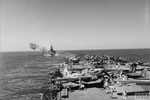 HMS Valiant during a 15" practice shoot from HMS Illustrious, in the Indiana Ocean on December 22, 1942. The planes in the foreground are Fairey Fulmars of 806 Squadron, Fleet Air Arm. Photo: Lt. D. C. Oulds. Imperial War Museums A 15153
