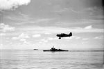 A Grumman Martlet fighter of 888 Squadron, Fleet Air Arm from the aircraft carrier HMS Formidable flying over HMS Warspite while circling to land during operations round Madagascar. The force left Colombo on April 24, 1942 and put into the Seychelles on May 1. The Fleet Air Arm carried out extensive searches and patrols over a wide area during the operation. The covering force then put into Mombasa on May 10 after the operation was concluded. Photo: Lt. D. C. Ouids. Imperial War Museums A 9712