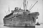 SS Nieuw Amsterdam in Melbourne Harbour, Victoria, Australia on February 25, 1943. Members of 9th Australian Division line the rails of the SS Nieuw Amsterdam, as she returns from the Middle East and is about to berth at the wharf so members from Victoria can disembark. Photo: Colin Thomas Halmarick. Australian War Memorial 101186