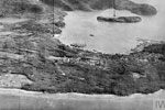 Sabang Bay from the North-East with special features indicated by arrows. These include Kelas Island, the airfield, oil tanks, and the Bergmeer mountain lake. Operation Cockpit against Sabang, April 19, 1944. Imperial War Museums A 23480