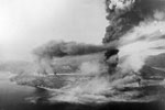 Columns of smoke rising from bombed oil tanks, burning docks, warehouses, and machine-gunned Japanese planes, etc. after the attack on Sabang. Operation Cockpit, April 19, 1944. Imperial War Museums A 23252