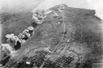 Bombs bursting on a runway during the attack by British naval aircraft on the airfield at Ishigaki, in the Sakishima Islands in May 1945. Imperial War Museums A 29173