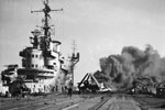 Firefighters busy on board HMS Formidable after a Japanese suicide plane had crashed on the flight deck. A Chance-Vought Corsair with its wings folded can be seen next to the badly scorched island whilst black smoke pours from the burning wreckage at the far end of the flight deck. HMS Formidable was hit by a Kamikaze on May 4 and again on May 9. Imperial War Museums A 29313