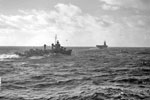The American aircraft carrier USS Wasp followed by a destroyer make their way towards port. April 3-4 1942. Photo: Lt. R. G. G. Coote. Imperial War Museum A 9233