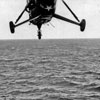 Dragonfly helicopter delivering mail, February 13, 1951. The helicopter is from USS Newport News (CA-148 Heavy Cruiser). Photo from my dad's albums.