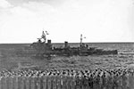 HMNZS Gambia with her crew manning the rails as the US aircraft carrier USS Saratoga was leaving the Indian Ocean on May 18, 1944. The crew of the Saratoga is rendering honours in the foreground. PHoto: United States Navy National Museum of Naval Aviation