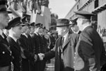 Mr Jordan, High Commissioner of New Zealand, attending the formal handing over of HMS Gambia in Liverpool, October 3, 1943. Here Mr Jordan is talking to officers of the ship. Photo: Lt. C. H. Parnall. Imperial War Museums A 19582