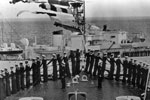 Royal Yacht Surprise passes the bows of HMS Vanguard. Image from Ray Holden