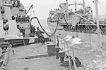 HMS Jamaica refueling at sea in September 1944. In the foreground is a rating holding a marked line which enables the navigator watching from the bridge to keep a true course during the operation. The tanker is probably RFA Empire Salvage. Photo: Imperial War Museums A25705.