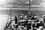 HMS Wrangler anchored off Samos with medical supplies of stores and food for the village, August 1953. Image from Imperial War Museums, A32639